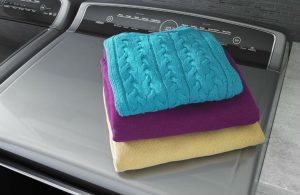 Image of folded towels on top of a washer